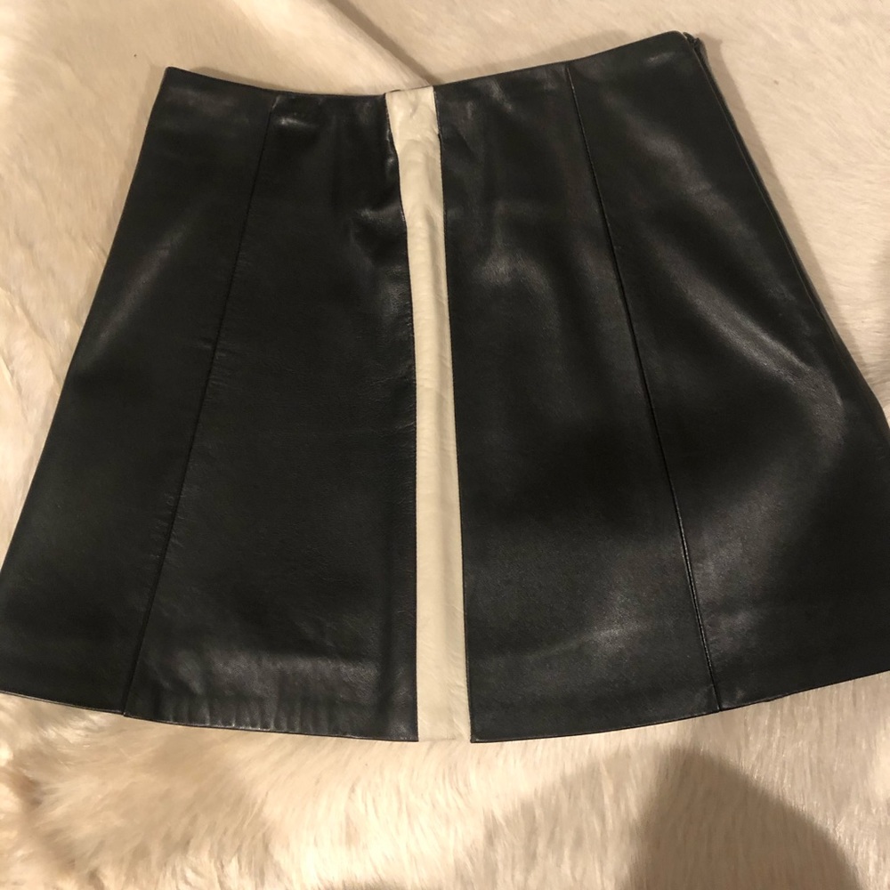 Mini leather skirt with stripes on side